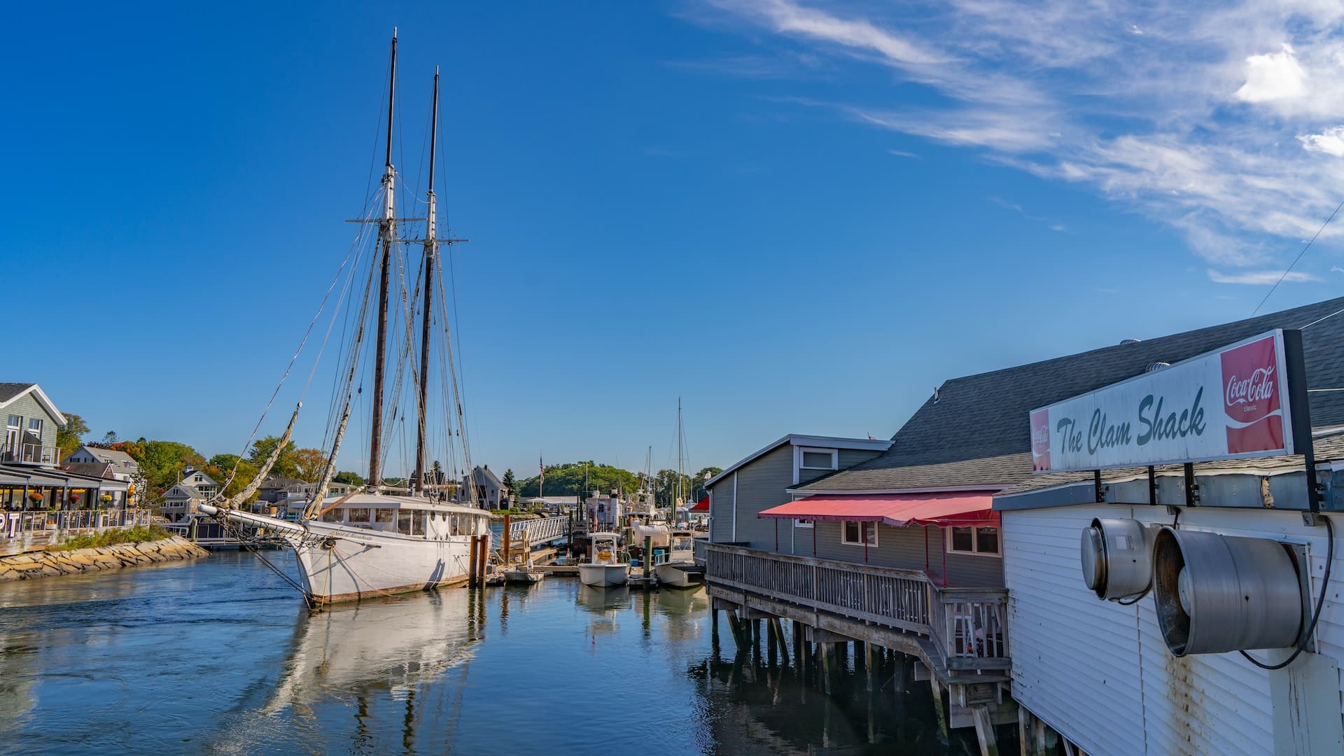Beautiful Kennebunkport in Maine, USA. You can see a gorgeous sailing boat and a snack bar called The Clam Shack, which is up on stilts.